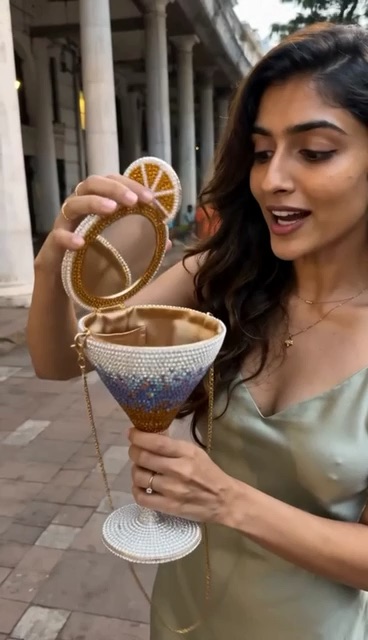 Opening a jeweled cocktail-glass bag to reveal its mirrored interior