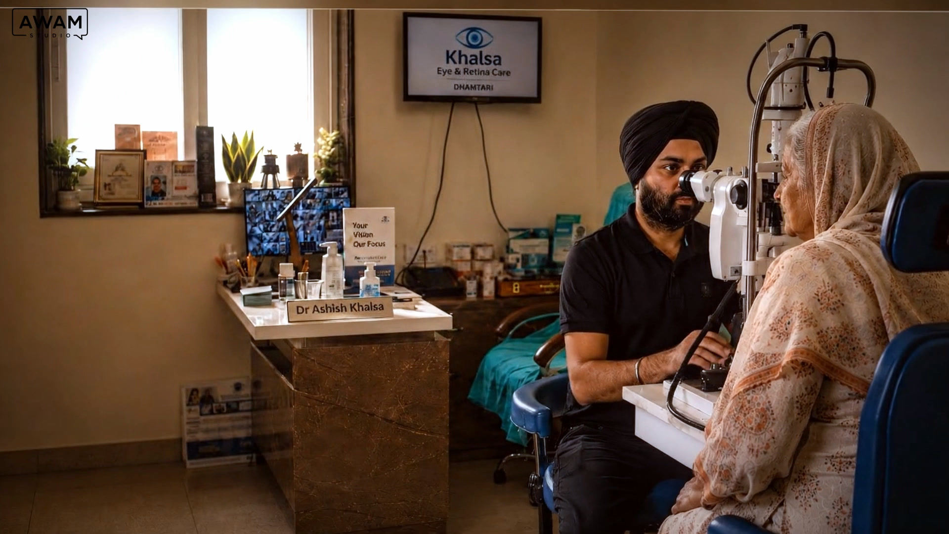 Dr Ashish Khalsa examines a patient at the slit lamp beneath the Khalsa Eye & Retina Care screen in Dhamtari.